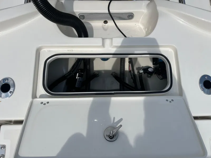 Slide: The Image of Open compartment on Avenger AV26 boat, showcasing internal components and wiring, 2026 model. - 29