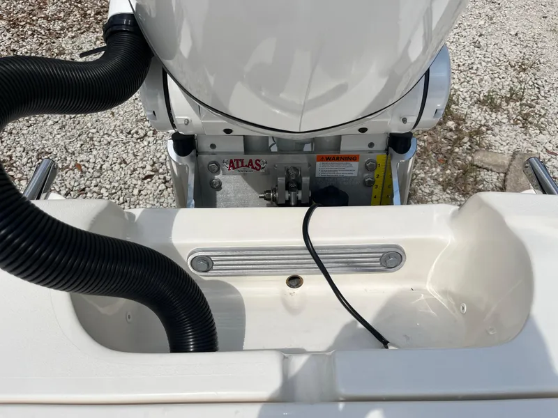 Slide: The Image of 2026 Avenger AV26 boat engine compartment with Atlas equipment and warning label. - 30