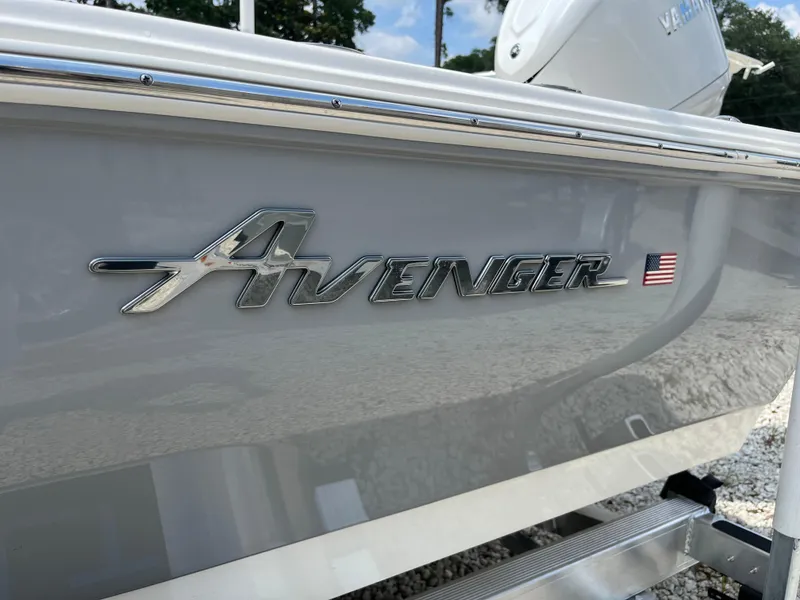 Slide: The Image of Avenger AV26 2026 boat logo with American flag emblem on sleek hull. - 33