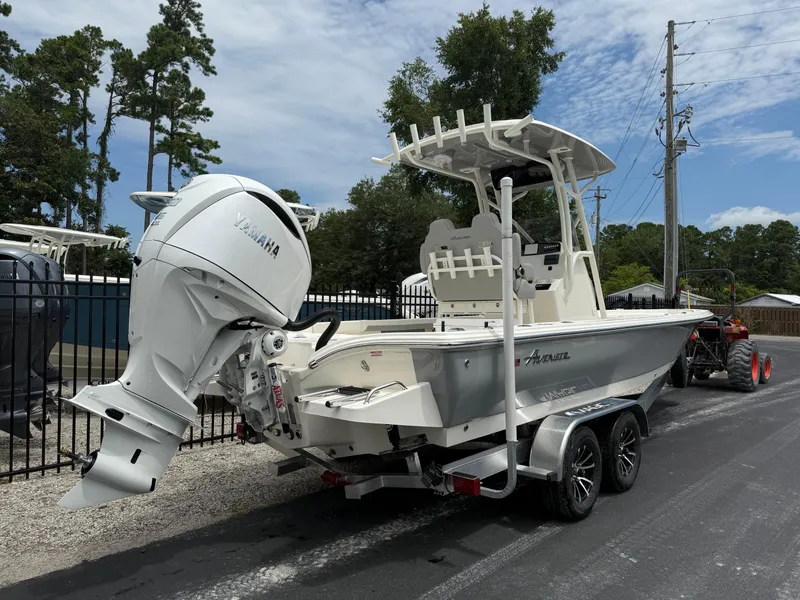 Slide: The Image of 2026 Avenger AV26 boat with Yamaha engine on trailer, parked outdoors. - 4