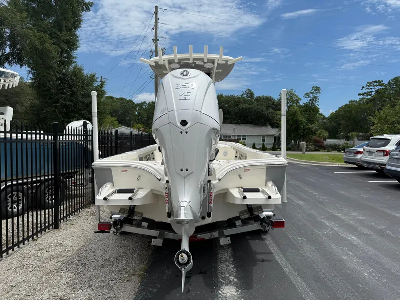 Slide: The Image of 2026 Avenger AV26 boat with powerful outboard motor, parked on a sunny day. - 5
