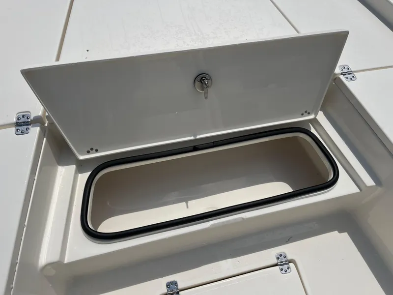 Slide: The Image of Open storage compartment on 2026 Avenger AV26 boat deck. - 8