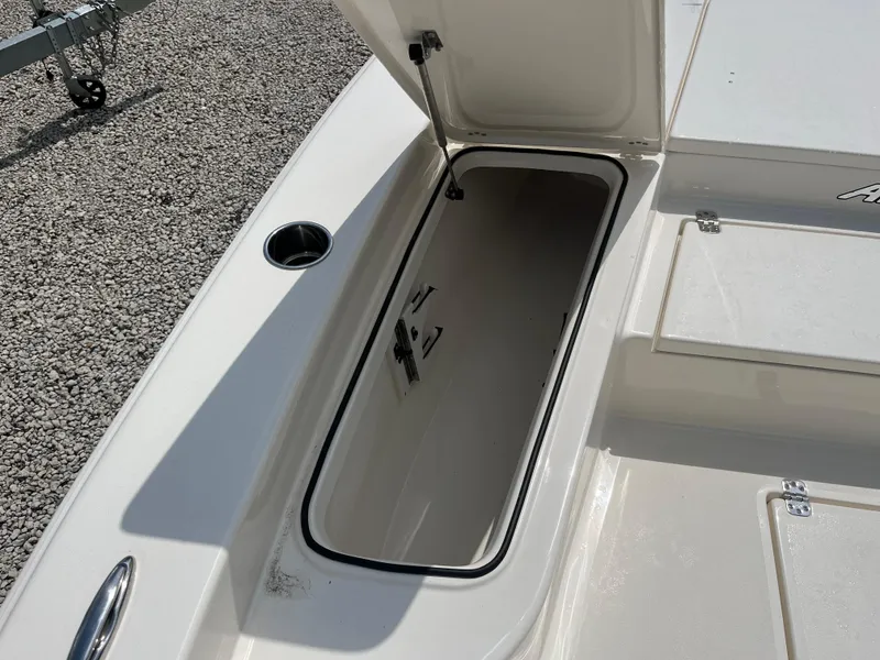 Slide: The Image of Open storage compartment on 2026 Avenger AV26 boat, showing interior space. - 9