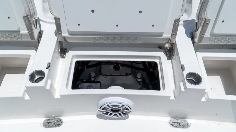 Slide: The Image of 2026 Tidewater 2700 Carolina Bay boat storage compartments and speaker detail. - 14
