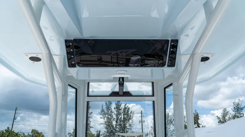 Slide: The Image of 2026 Tidewater 2700 Carolina Bay boat interior with modern console and clear sky view. - 15