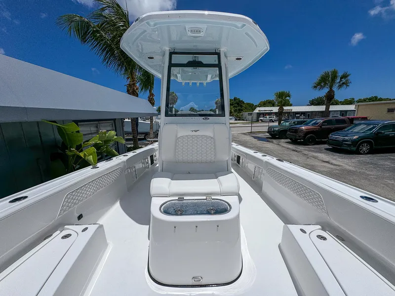 Slide: The Image of 2026 Tidewater 2700 Carolina Bay boat with center console, parked outdoors under blue sky. - 24