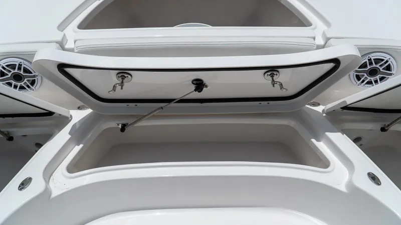 Slide: The Image of 2026 Tidewater 2700 Carolina Bay boat storage compartments with open hatches and speakers. - 28