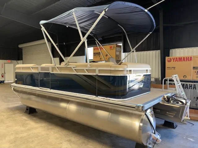 Slide: The Image of 2025 Tahoe Pontoon STX 1980 CR with canopy in a warehouse setting. - 10