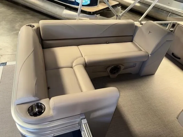 Slide: The Image of 2025 Tahoe Pontoon STX 1980 CR interior seating with beige upholstery and cup holders. - 11