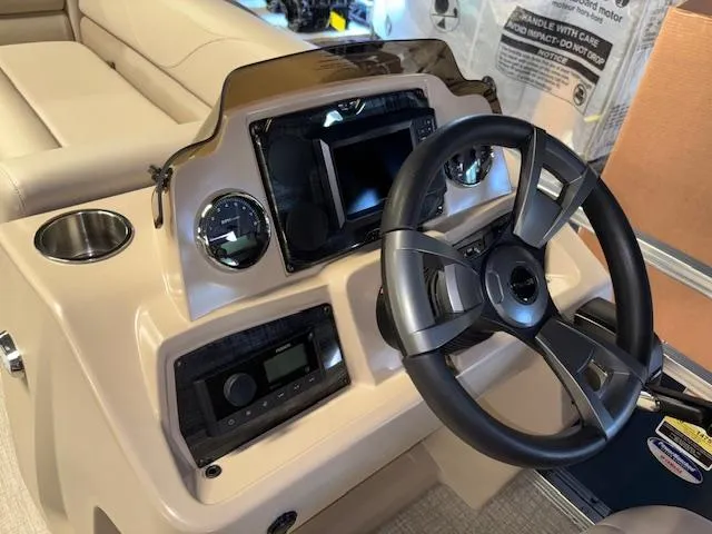 Slide: The Image of 2025 Tahoe Pontoon STX 1980 CR dashboard with steering wheel and controls. - 12