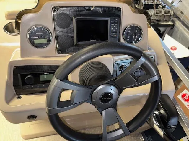 Slide: The Image of 2025 Tahoe Pontoon STX 1980 CR dashboard with steering wheel and control panel. - 13