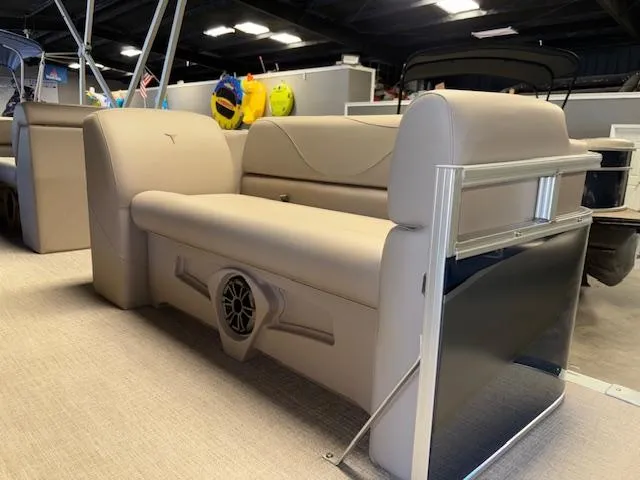 Slide: The Image of 2025 Tahoe Pontoon STX 1980 CR interior with beige seating and speaker system. - 4