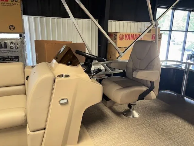 Slide: The Image of 2025 Tahoe Pontoon STX 1980 CR interior with captain's chair and steering console. - 7