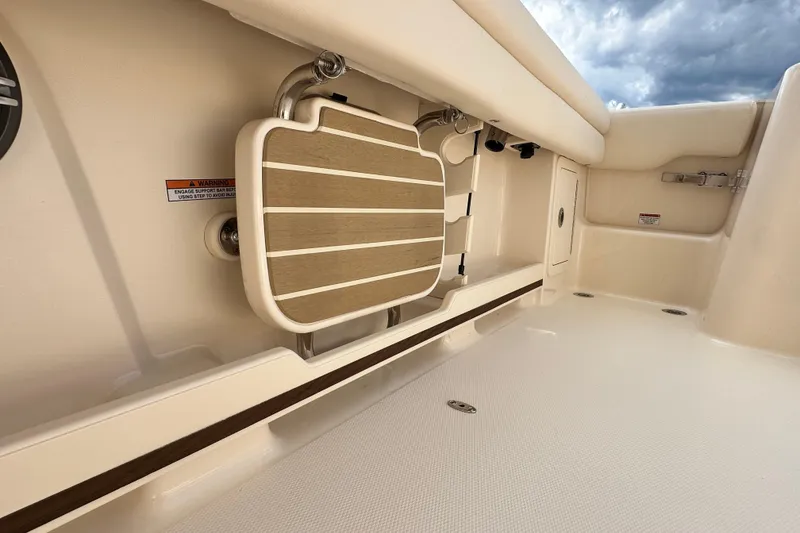 Slide: The Image of 2026 Grady-White Freedom 235 boat interior, featuring a foldable seat and storage compartment. - 15