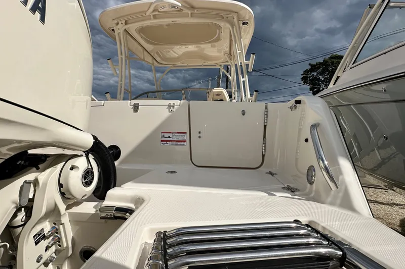 Slide: The Image of 2026 Grady-White Freedom 235 boat interior with Yamaha engine, showcasing sleek design. - 4