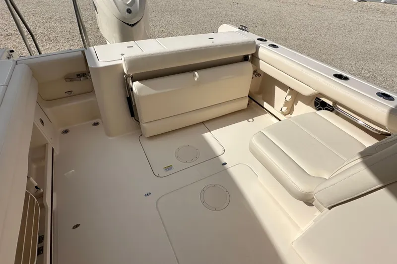 Slide: The Image of 2026 Grady-White Freedom 235 boat interior with beige seating and spacious deck layout. - 7