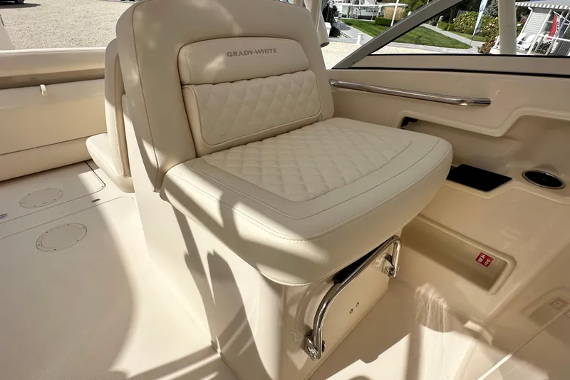 Slide: The Image of 2026 Grady-White Freedom 235 boat interior with luxurious cream seating and elegant design. - 8