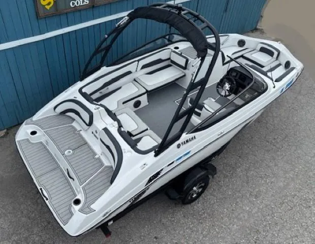Slide: The Image of 2022 Yamaha AR195 boat with sleek design, spacious seating, and modern features, parked on a trailer. - 10