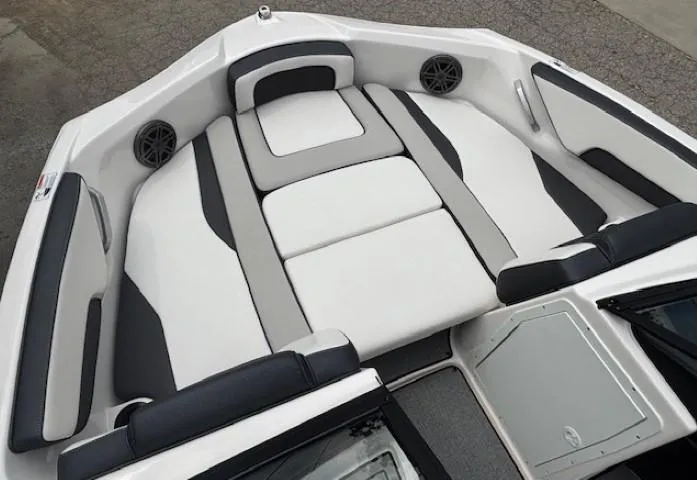 Slide: The Image of 2022 Yamaha AR195 boat interior with sleek, modern seating and built-in speakers. - 13
