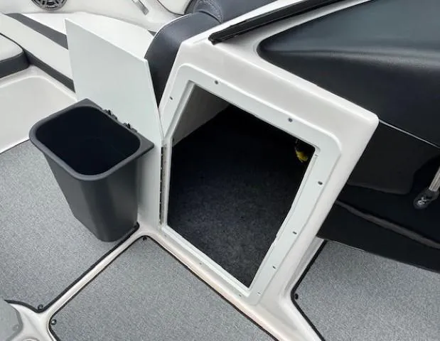 Slide: The Image of 2022 Yamaha AR195 boat interior storage compartment with trash bin. - 16