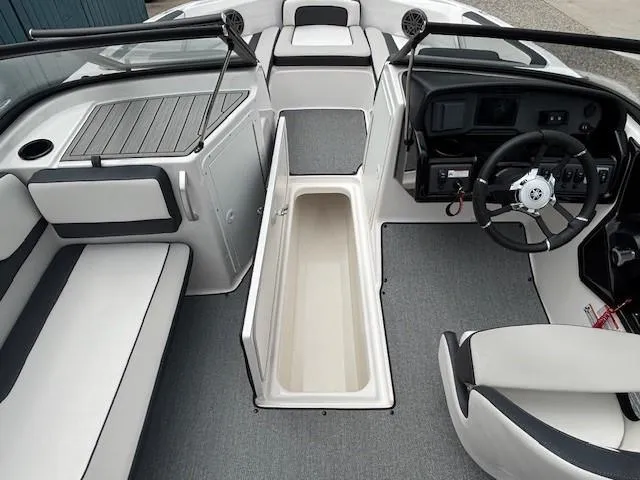 Slide: The Image of 2022 Yamaha Boats AR195 interior with seating, steering wheel, and storage compartment. - 18