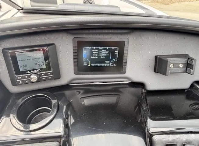 Slide: The Image of Dashboard of 2022 Yamaha Boats AR195 with digital displays and cup holder. - 21