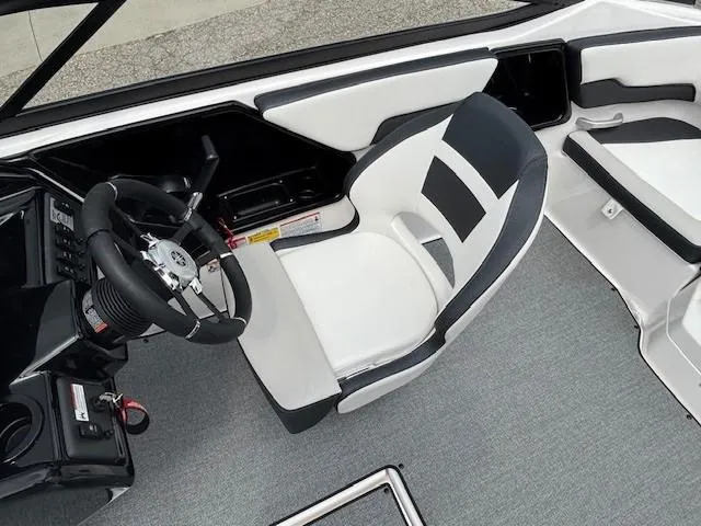 Slide: The Image of 2022 Yamaha Boats AR195 cockpit with sleek steering wheel and modern seating design. - 22