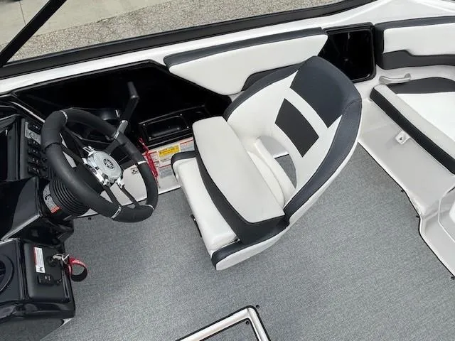 Slide: The Image of 2022 Yamaha Boats AR195 cockpit with steering wheel and cushioned seat. - 23