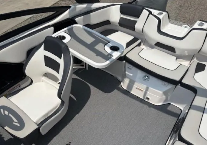 Slide: The Image of 2022 Yamaha Boats AR195 interior with seating and table, featuring modern design and comfort. - 26