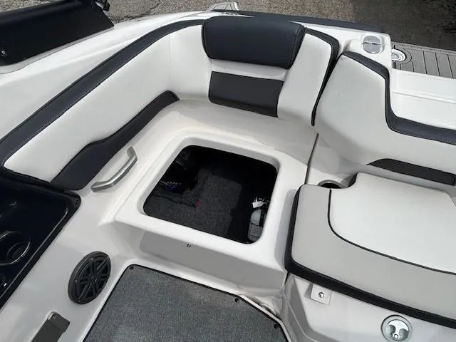 Slide: The Image of 2022 Yamaha AR195 boat interior with open storage compartment and cushioned seating. - 28