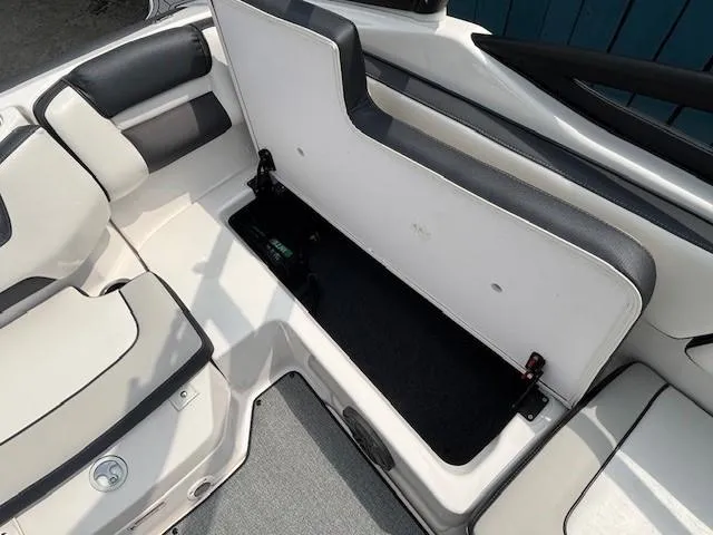 Slide: The Image of 2022 Yamaha AR195 boat interior with open storage compartment and cushioned seating. - 29