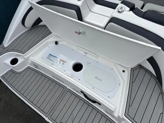 Slide: The Image of 2022 Yamaha AR195 boat storage compartment with open hatch, showcasing sleek design and functionality. - 33