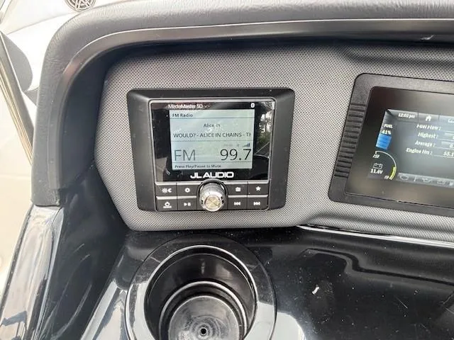 Slide: The Image of Yamaha AR195 2022 boat dashboard with JL Audio system displaying FM 99.7. - 34