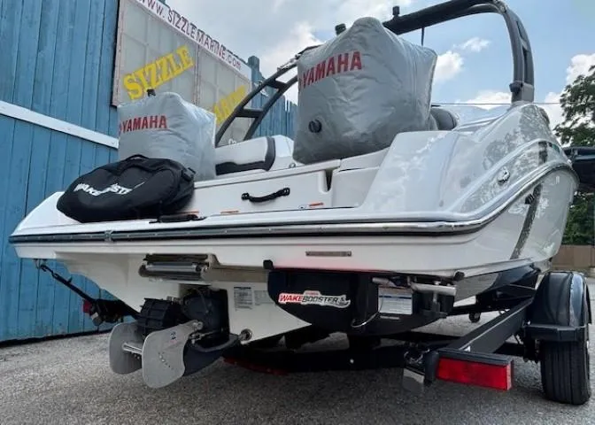 Slide: The Image of 2022 Yamaha AR195 boat rear view with covered seats and trailer. - 8