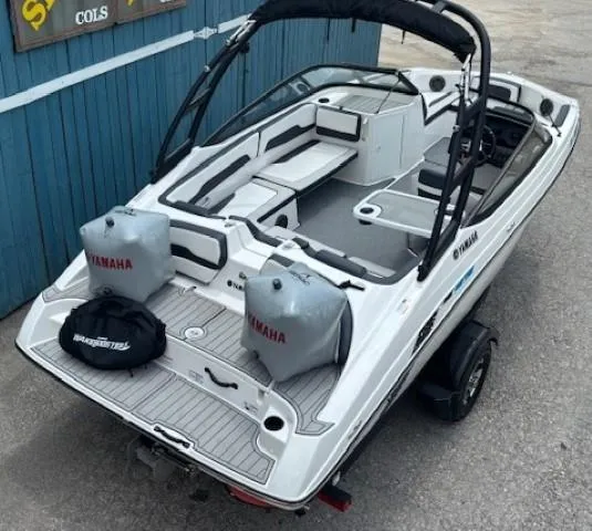 Slide: The Image of 2022 Yamaha Boats AR195, sleek design, white exterior, spacious interior, docked on trailer. - 9