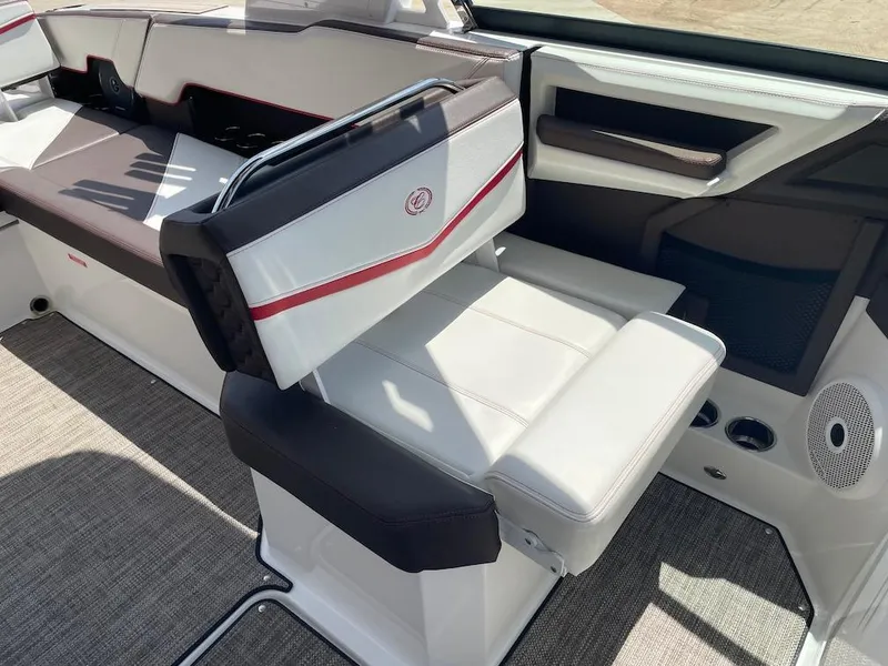 Slide: The Image of 2023 Cobalt R8 Surf boat interior with white and black seating, red accents, and modern design. - 17