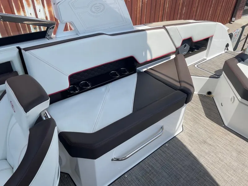 Slide: The Image of 2023 Cobalt R8 Surf boat interior with white and black seating, cup holders, and sleek design. - 19