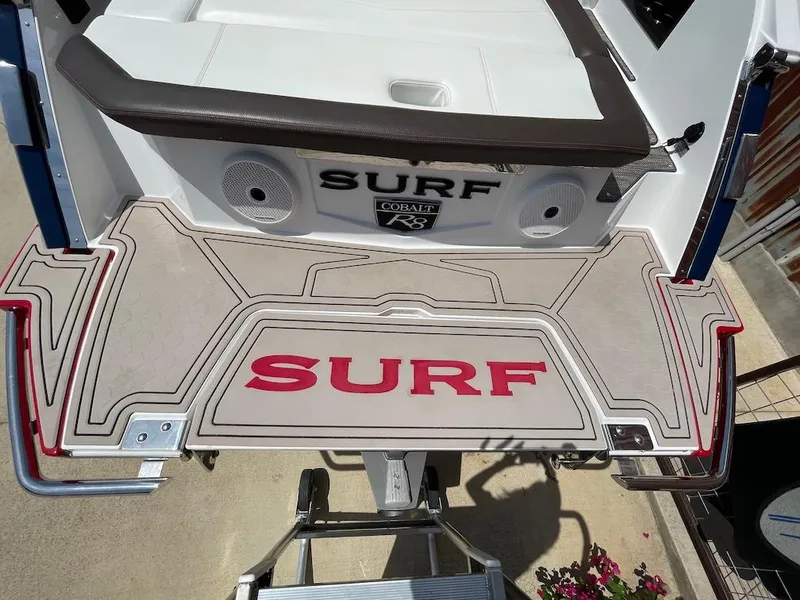 Slide: The Image of 2023 Cobalt R8 Surf boat platform with "SURF" branding and integrated speakers. - 4
