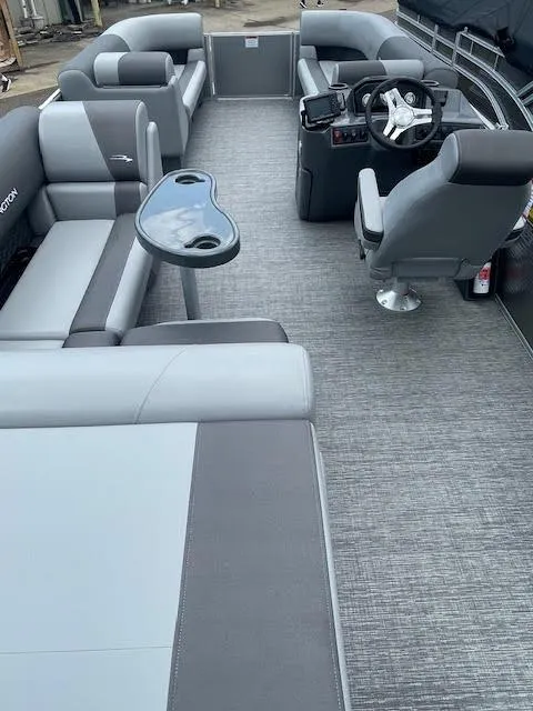 Slide: The Image of 2024 Bennington 22 SLSR Cruise pontoon boat interior with gray seating and steering console. - 3