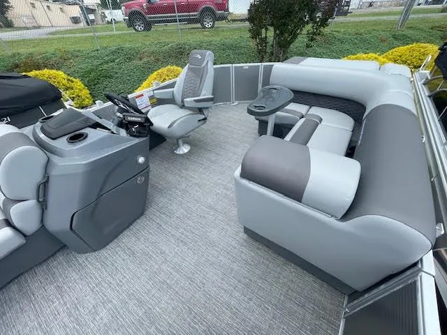 Slide: The Image of 2024 Bennington 22 SLSR Cruise pontoon boat interior with gray seating and helm. - 5
