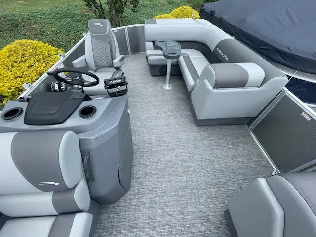 Slide: The Image of 2024 Bennington 22 SLSR Cruise pontoon boat interior with gray seating and helm. - 8