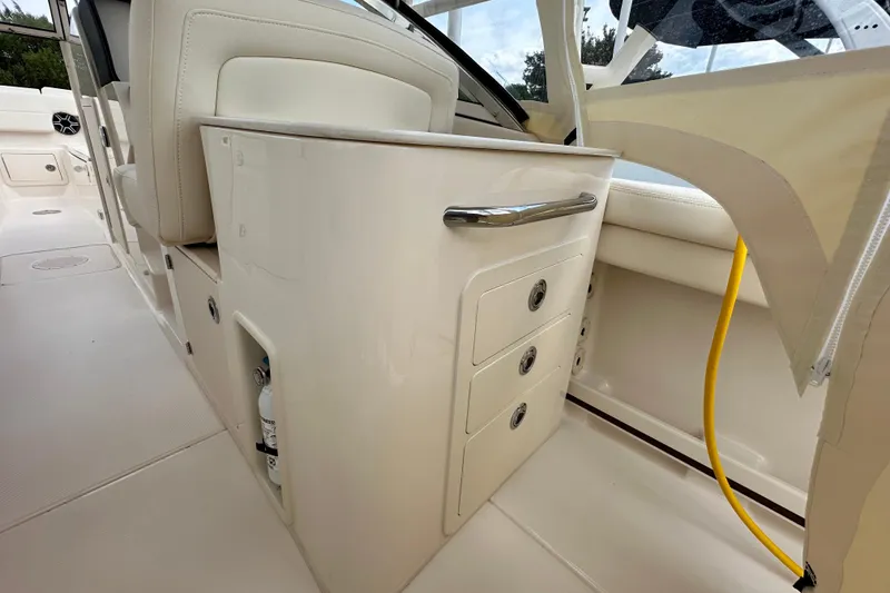 Slide: The Image of 2026 Grady-White Freedom 275 boat interior with storage drawers and seating. - 11