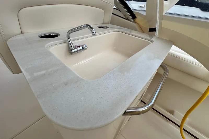 Slide: The Image of Luxury sink area on 2026 Grady-White Freedom 275 boat, featuring modern design and chrome fixtures. - 12