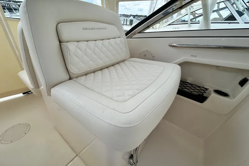 Slide: The Image of Luxurious seating on 2026 Grady-White Freedom 275 boat, featuring quilted white upholstery. - 14