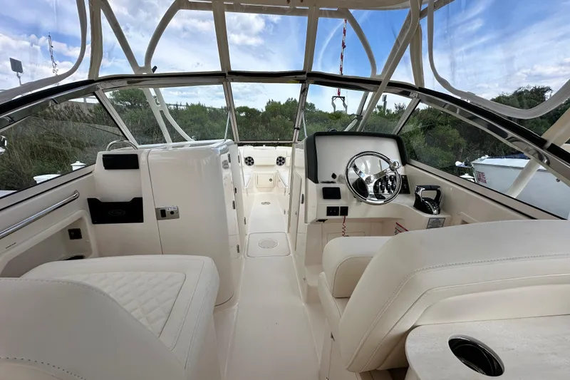 Slide: The Image of 2026 Grady-White Freedom 275 boat interior with steering wheel and seating. - 20