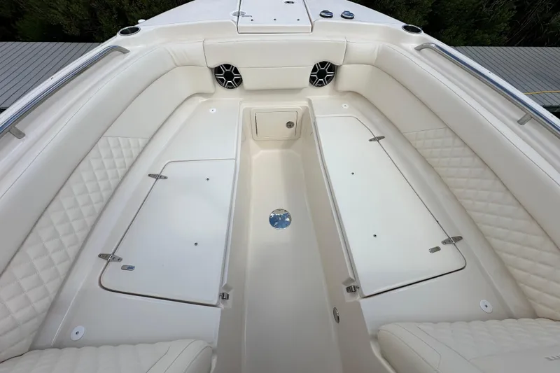 Slide: The Image of 2026 Grady-White Freedom 275 boat interior with cushioned seating and storage compartments. - 22