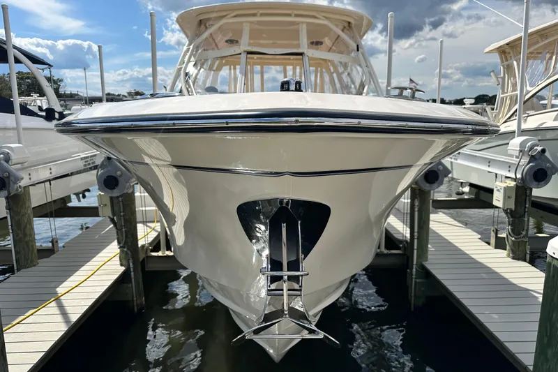 Slide: The Image of 2026 Grady-White Freedom 275 boat docked at marina under blue sky. - 4