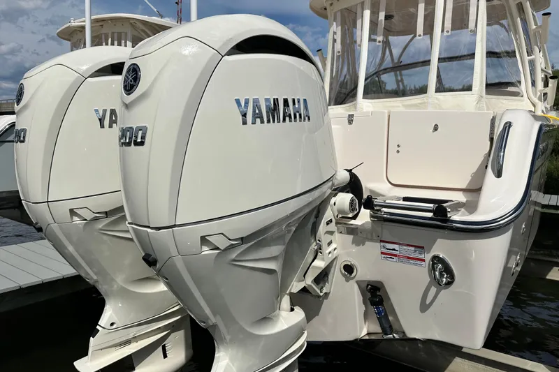 Slide: The Image of 2026 Grady-White Freedom 275 boat with dual Yamaha outboard engines at dock. - 6