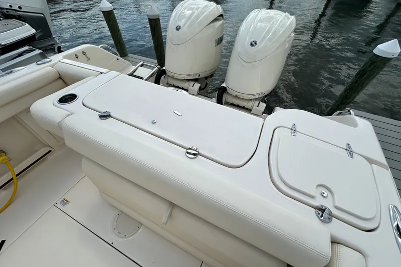 Slide: The Image of 2026 Grady-White Freedom 275 boat with dual outboard engines at dock. - 9