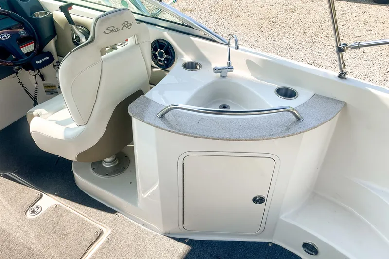 Slide: The Image of 2007 Sea Ray 260 Sundeck interior with captain's chair and sink area. - 11